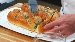spread the garlic butter throughout your garlic bread