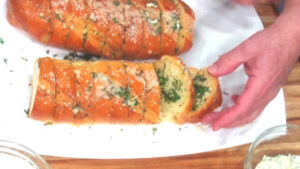 For the best garlic bread use a French baguette or a dense Italian bread